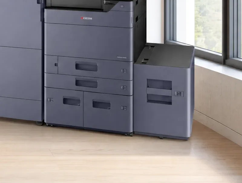 Three paper drawers and a high capacity side deck at the base of a Kyocera multifunction printer